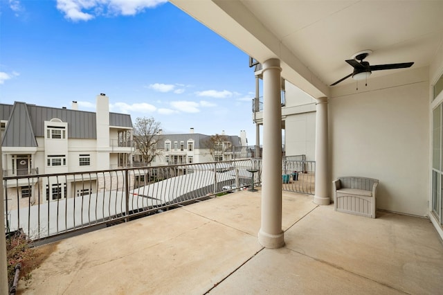 balcony featuring a ceiling fan and a residential view