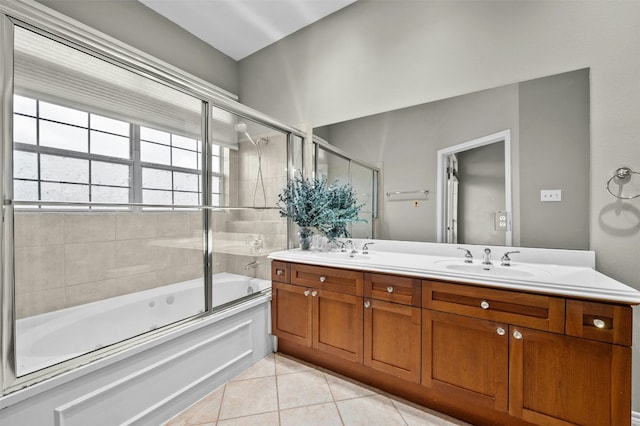 bathroom featuring double vanity, enclosed tub / shower combo, tile patterned flooring, and a sink