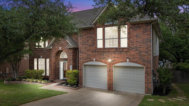 view of front of home featuring concrete driveway, brick siding, and an attached garage