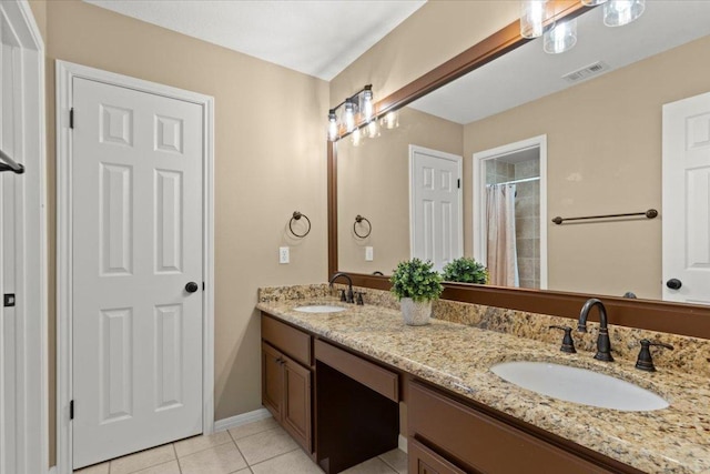 bathroom with curtained shower, visible vents, tile patterned flooring, and a sink