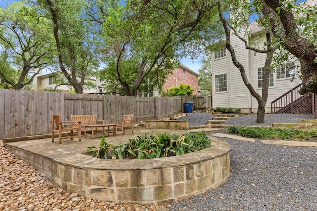 view of yard featuring stairs and a fenced backyard