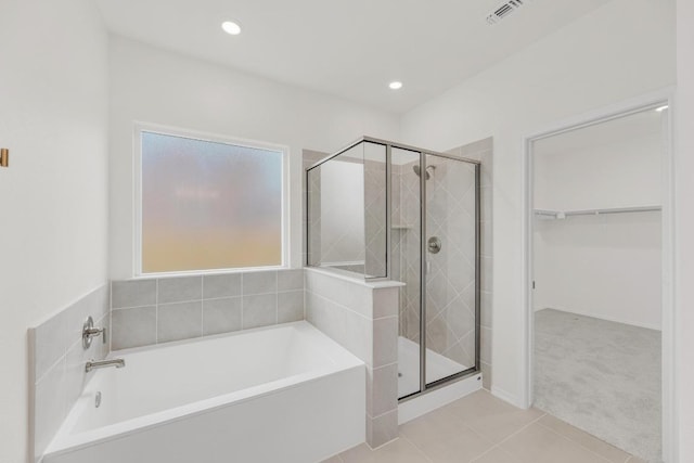 4847 Padula Dr, Round Rock, TX 78665 - full bath featuring a garden tub, a shower stall, tile patterned floors, a walk in closet, and recessed lighting
