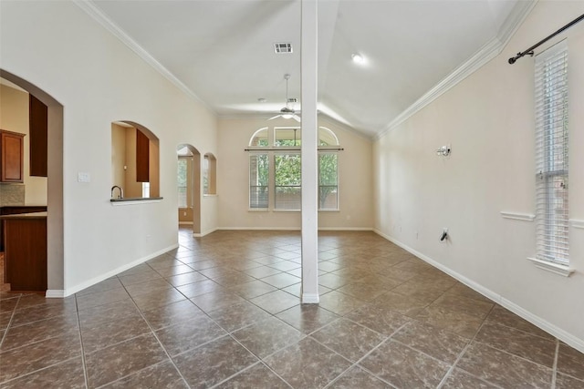 2213 Settlers Park Loop, Round Rock, TX 78665 - unfurnished living room with a ceiling fan, crown molding, lofted ceiling, arched walkways, and dark tile patterned floors
