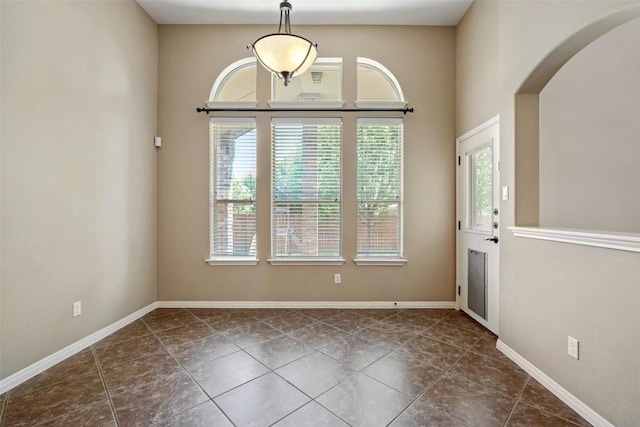 2213 Settlers Park Loop, Round Rock, TX 78665 - spare room with arched walkways, tile patterned flooring, and baseboards
