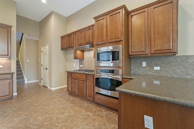2213 Settlers Park Loop, Round Rock, TX 78665 - kitchen featuring appliances with stainless steel finishes, brown cabinetry, dark stone counters, and light tile patterned floors