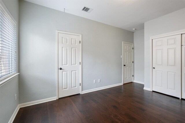 2213 Settlers Park Loop, Round Rock, TX 78665 - unfurnished bedroom with dark wood-style floors and baseboards