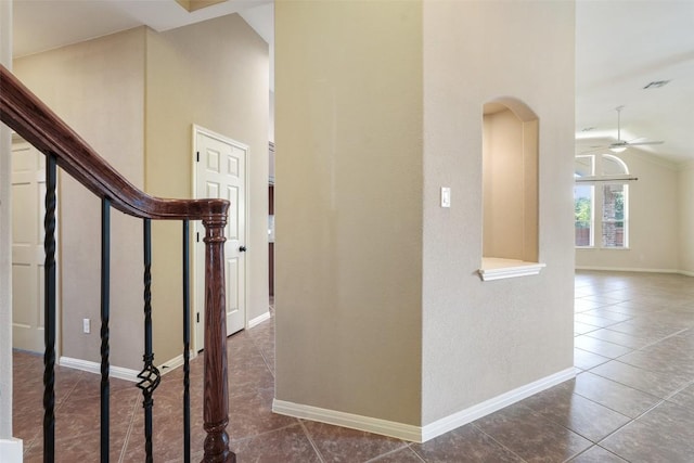 2213 Settlers Park Loop, Round Rock, TX 78665 - hall with dark tile patterned flooring, lofted ceiling, arched walkways, stairway, and baseboards