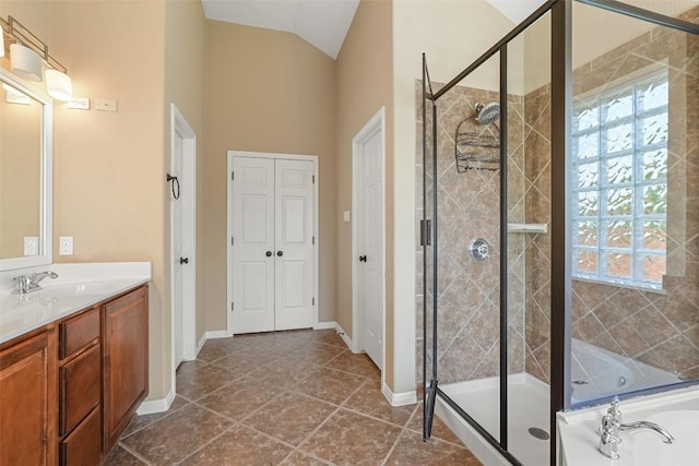 2213 Settlers Park Loop, Round Rock, TX 78665 - bathroom featuring a stall shower, vanity, a garden tub, lofted ceiling, and baseboards