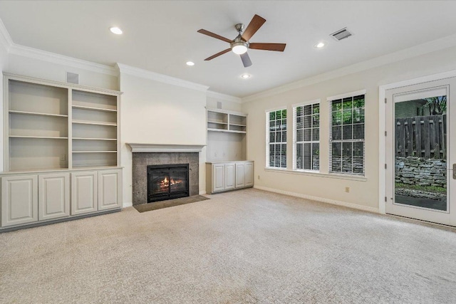 unfurnished living room with ornamental molding, a ceiling fan, visible vents, and a fireplace