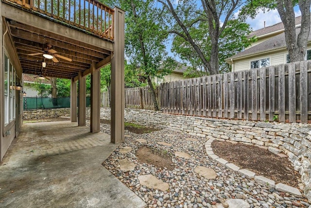view of yard featuring a ceiling fan, a fenced backyard, and a patio area