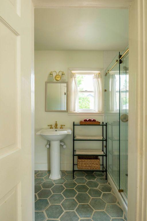 full bath with tile patterned floors and a stall shower