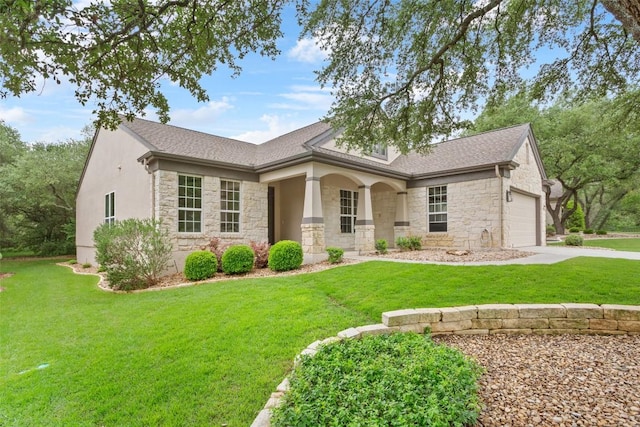 204 San Saba Dr, Georgetown, TX 78633 - view of front of home featuring a shingled roof, a front lawn, stone siding, a garage, and concrete driveway