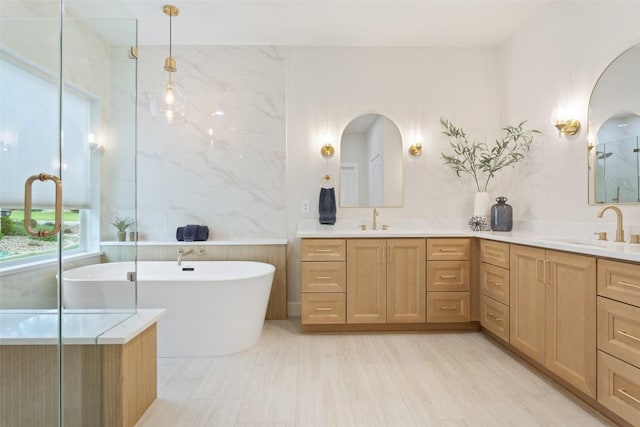 204 San Saba Dr, Georgetown, TX 78633 - bathroom featuring a sink, a shower with shower door, double vanity, and a freestanding bath