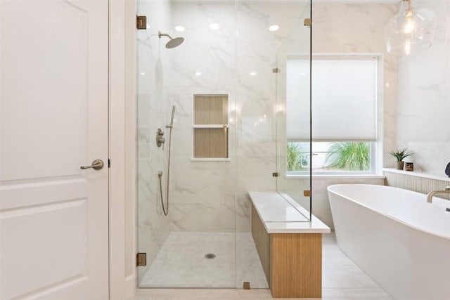 204 San Saba Dr, Georgetown, TX 78633 - bathroom featuring a marble finish shower and a freestanding tub