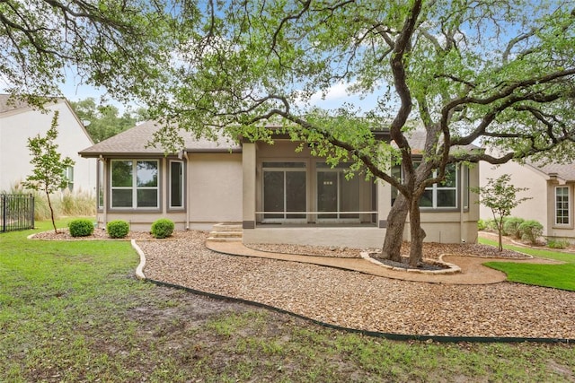 204 San Saba Dr, Georgetown, TX 78633 - back of house with a lawn, stucco siding, a sunroom, and fence