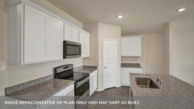 kitchen with dark wood-style floors, a sink, white cabinets, and appliances with stainless steel finishes