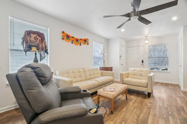 living area with baseboards, a ceiling fan, and recessed lighting