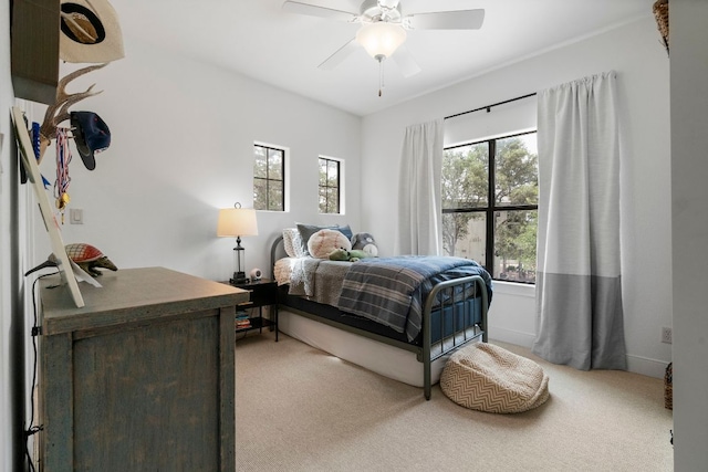 carpeted bedroom featuring a ceiling fan and baseboards