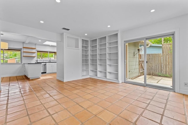 unfurnished living room with light tile patterned floors, visible vents, baseboards, recessed lighting, and built in shelves