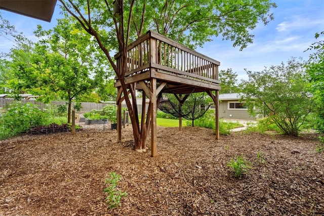view of yard featuring fence and a wooden deck