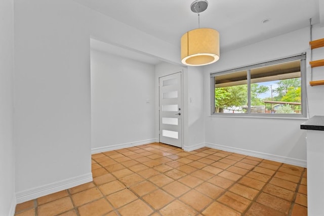 empty room featuring baseboards