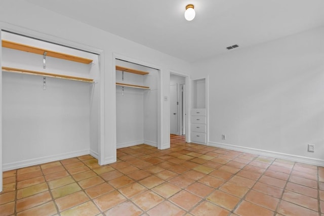 unfurnished bedroom featuring light tile patterned floors and visible vents