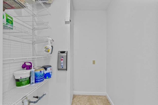 laundry area featuring baseboards