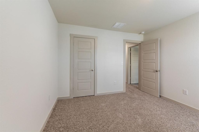 interior space with baseboards, visible vents, and carpet flooring