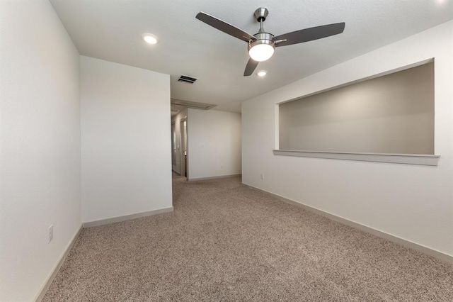 empty room featuring visible vents, ceiling fan, carpet flooring, and baseboards