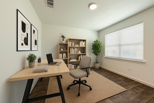office space featuring dark wood-style flooring, visible vents, and baseboards