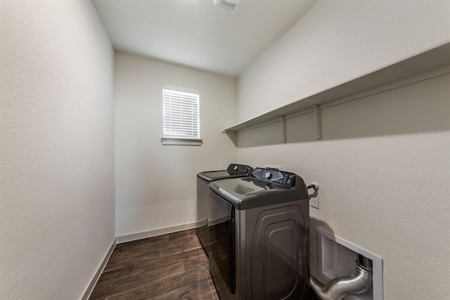 washroom featuring baseboards, independent washer and dryer, laundry area, and dark wood-type flooring