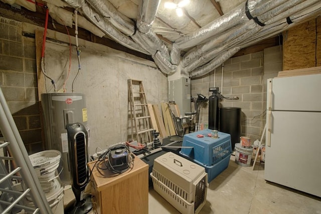 unfinished basement featuring freestanding refrigerator and electric water heater