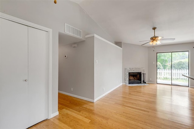 unfurnished living room featuring visible vents, ceiling fan, light wood-style floors, baseboards, and a tiled fireplace