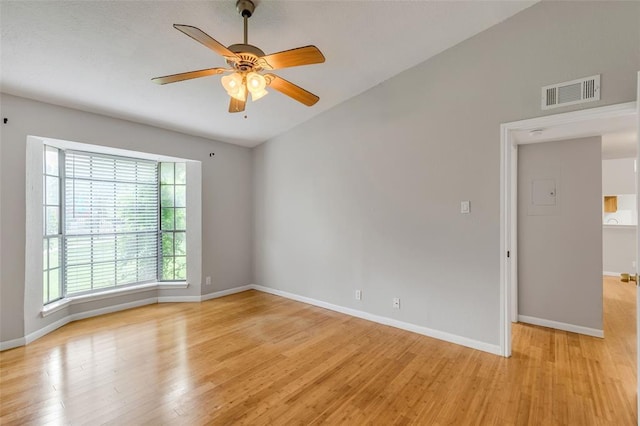 spare room with baseboards, visible vents, a ceiling fan, and light wood-style floors