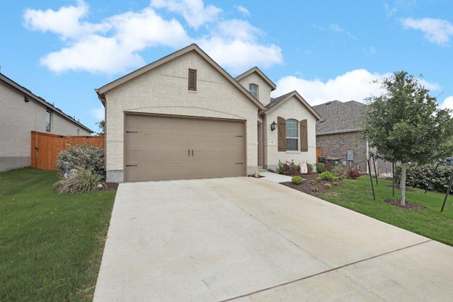 french country home with driveway, a garage, and brick siding