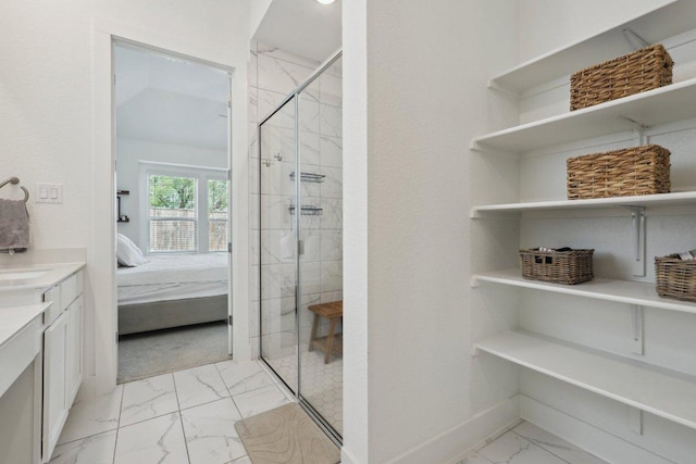 full bathroom featuring marble look tiles, ensuite bathroom, a shower stall, vanity, and baseboards