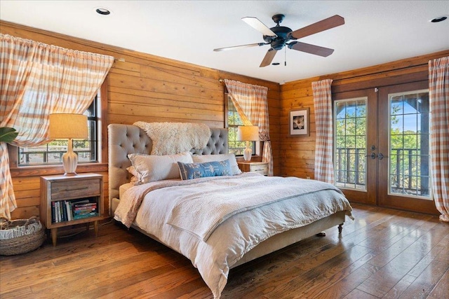 19801 Adrian Way, Jonestown, TX 78645 - bedroom featuring french doors, access to exterior, hardwood / wood-style floors, wood walls, and recessed lighting