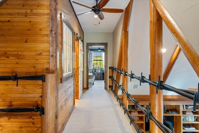 interior space featuring carpet floors and wood walls
