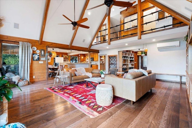 living area with beam ceiling, hardwood / wood-style floors, high vaulted ceiling, an AC wall unit, and a ceiling fan