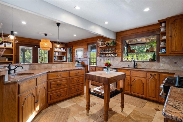 kitchen featuring brown cabinets, open shelves, and a sink