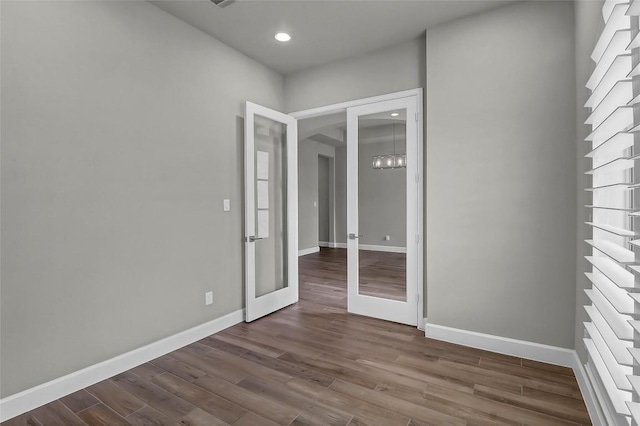 interior space with dark wood-style flooring, baseboards, recessed lighting, and french doors