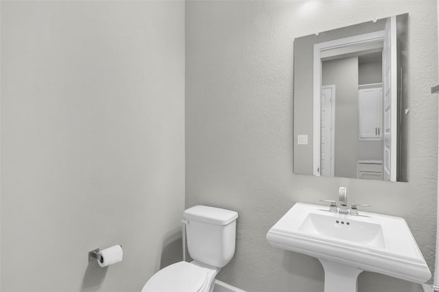 bathroom featuring a sink and toilet