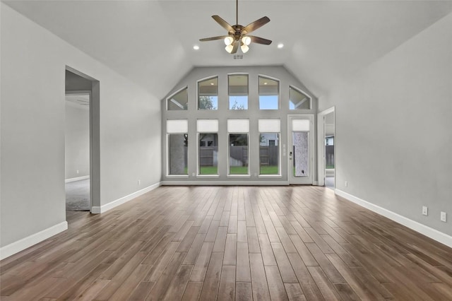 unfurnished living room featuring ceiling fan, wood finished floors, baseboards, lofted ceiling, and recessed lighting