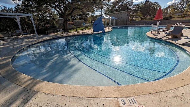 pool with a gazebo, a patio area, and fence