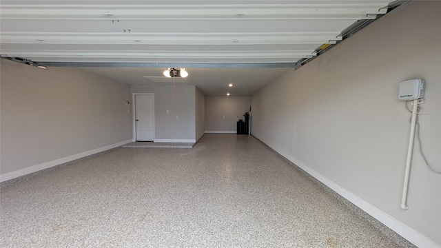 garage featuring baseboards and a garage door opener