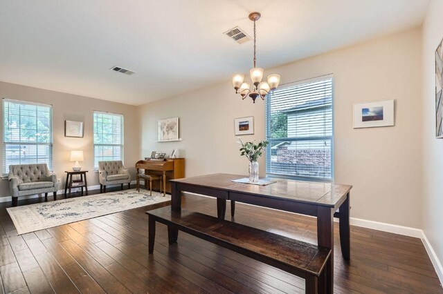 2106 Valerian Trl, Round Rock, TX 78665 - dining space with baseboards, dark wood-type flooring, and a chandelier