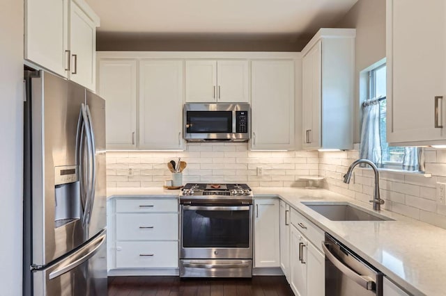 2106 Valerian Trl, Round Rock, TX 78665 - kitchen featuring appliances with stainless steel finishes, a sink, decorative backsplash, and white cabinets