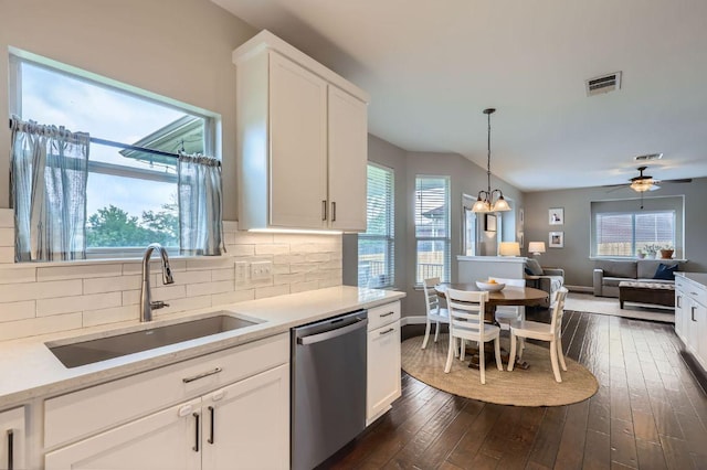 2106 Valerian Trl, Round Rock, TX 78665 - kitchen with dishwasher, a sink, dark wood-type flooring, tasteful backsplash, and white cabinetry
