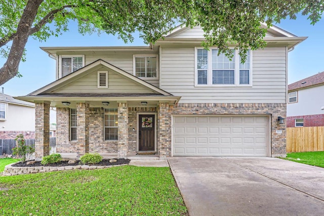 2106 Valerian Trl, Round Rock, TX 78665 - view of front of home with driveway, an attached garage, a porch, and brick siding
