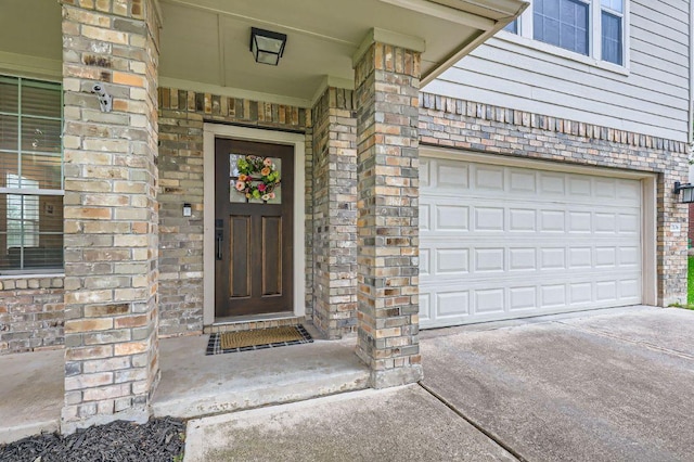 2106 Valerian Trl, Round Rock, TX 78665 - property entrance featuring brick siding, driveway, and an attached garage